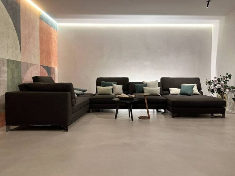 Ecksofa, geometrische Wand, indirektes Licht.